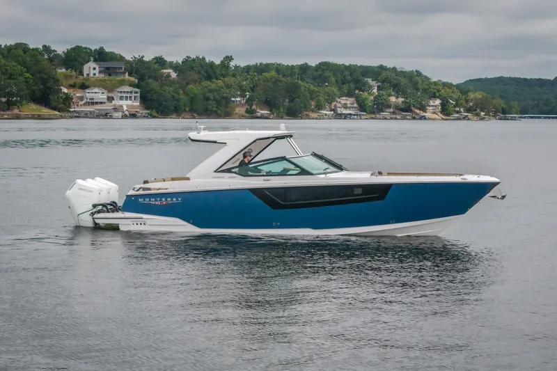 The Image of 2025 Monterey 385SS Super Sport boat on a calm lake with scenic background. - 1