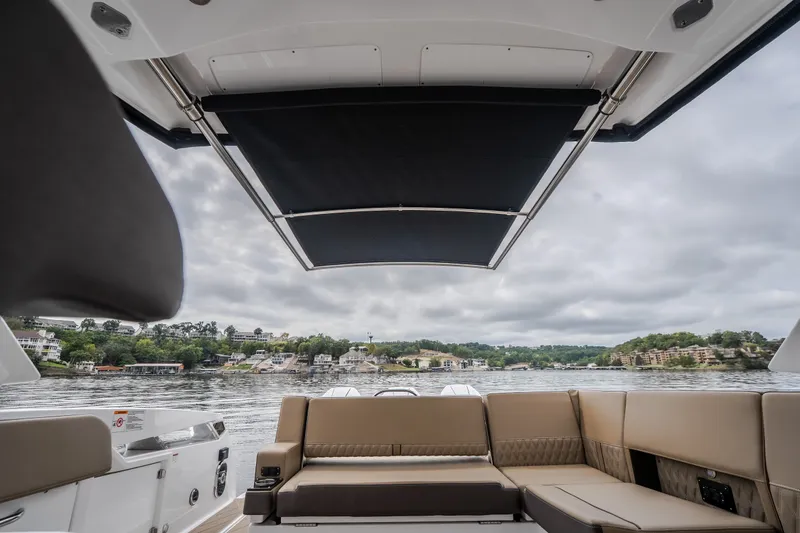 Slide: The Image of 2025 Monterey 385SS Super Sport boat interior with lake view and luxurious seating. - 53