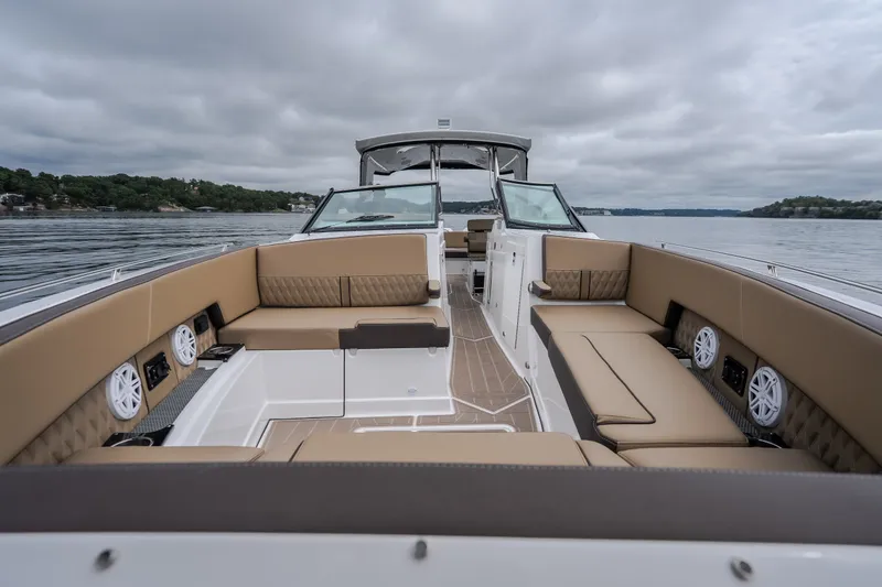 Slide: The Image of Luxurious 2025 Monterey 385SS Super Sport boat interior with spacious seating on a calm lake. - 47