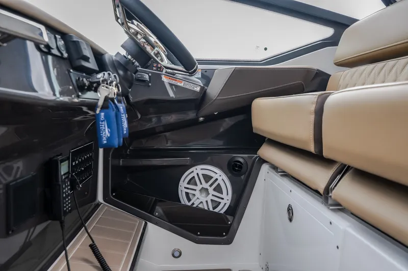 Slide: The Image of Interior of 2025 Monterey 385SS Super Sport boat with steering wheel and seating. - 24