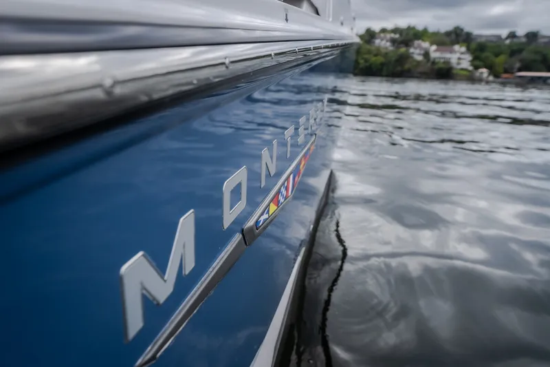 Slide: The Image of 2025 Monterey 385SS Super Sport boat on water, close-up side view. - 65