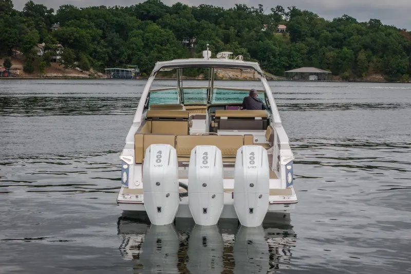 Slide: The Image of 2025 Monterey 385SS Super Sport boat with triple 400 V10 engines on a serene lake. - 7