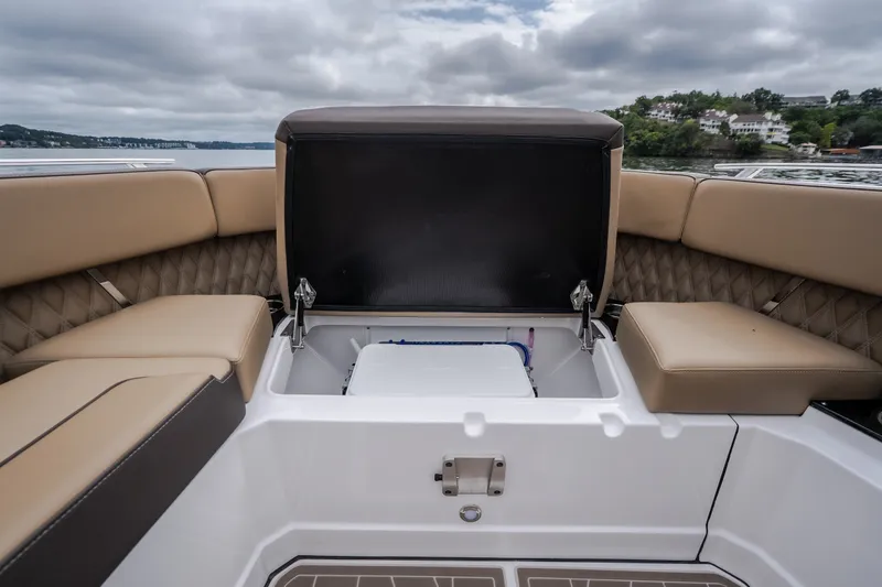 Slide: The Image of 2025 Monterey 385SS Super Sport boat interior with open storage compartment and cushioned seating. - 42