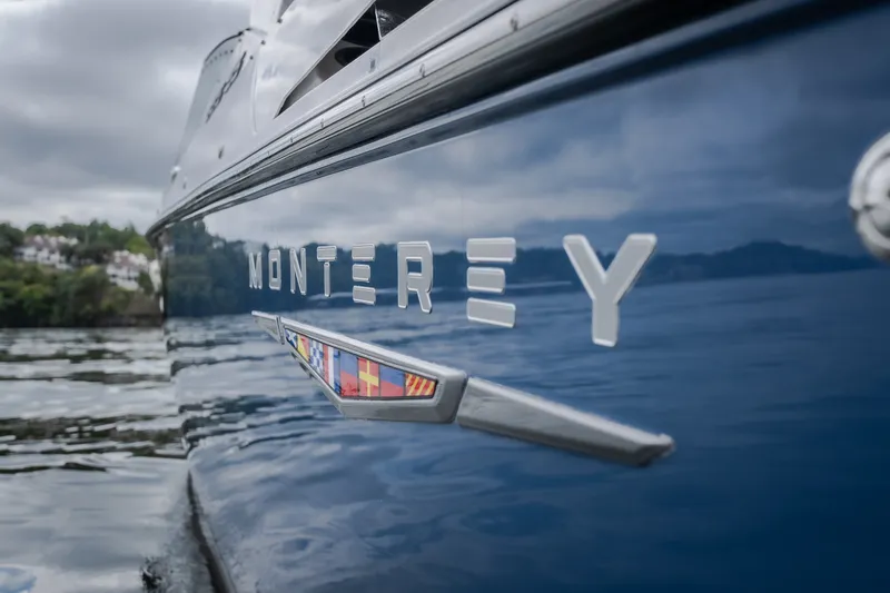 Slide: The Image of 2025 Monterey 385SS Super Sport boat on calm water, showcasing sleek design. - 5