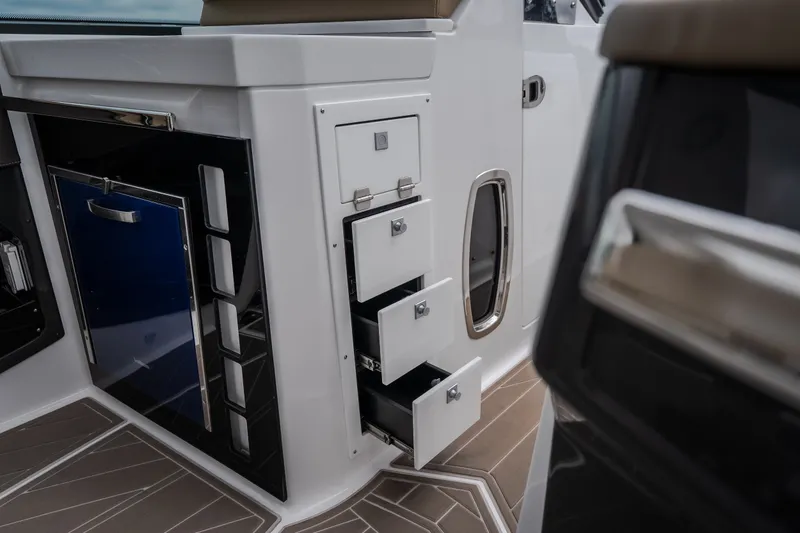 Slide: The Image of Interior view of 2025 Monterey 385SS Super Sport boat with open storage drawers. - 37