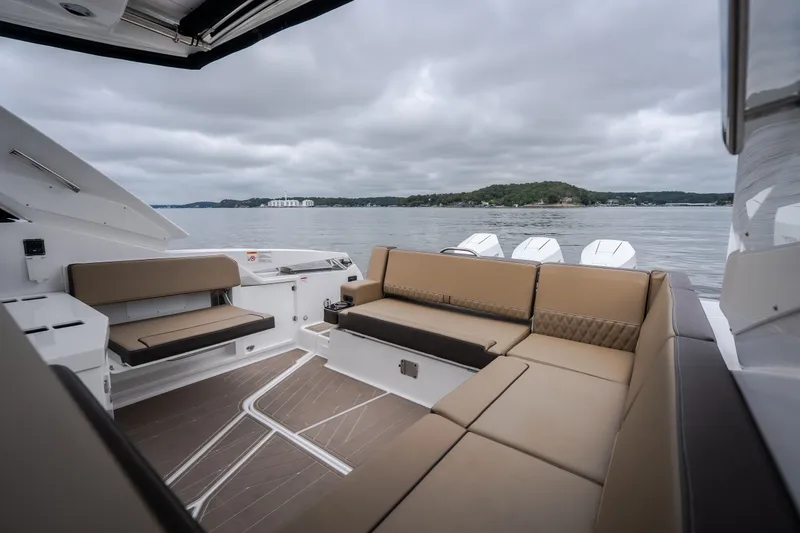 Slide: The Image of Luxurious seating on 2025 Monterey 385SS Super Sport boat with scenic lake view. - 56