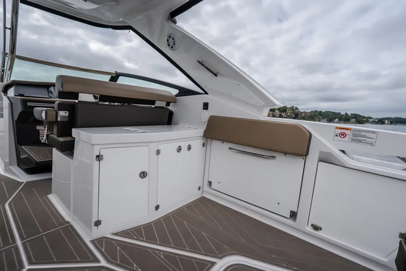 Slide: The Image of 2025 Monterey 385SS Super Sport boat interior with sleek seating and storage. - 13