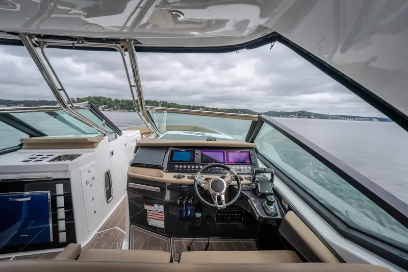 Slide: The Image of 2025 Monterey 385SS Super Sport boat cockpit with modern navigation system and scenic water view. - 16
