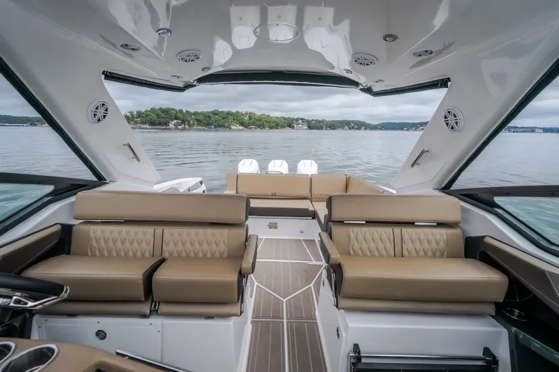Slide: The Image of Luxurious interior of 2025 Monterey 385SS Super Sport boat on a serene lake. - 49