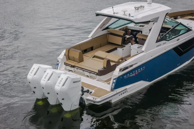 Slide: The Image of 2025 Monterey 385SS Super Sport boat with triple Mercury engines on water. - 4
