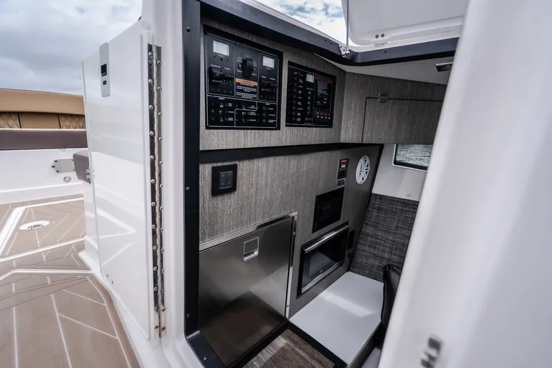 Slide: The Image of Interior of 2025 Monterey 385SS Super Sport boat with modern control panels. - 25