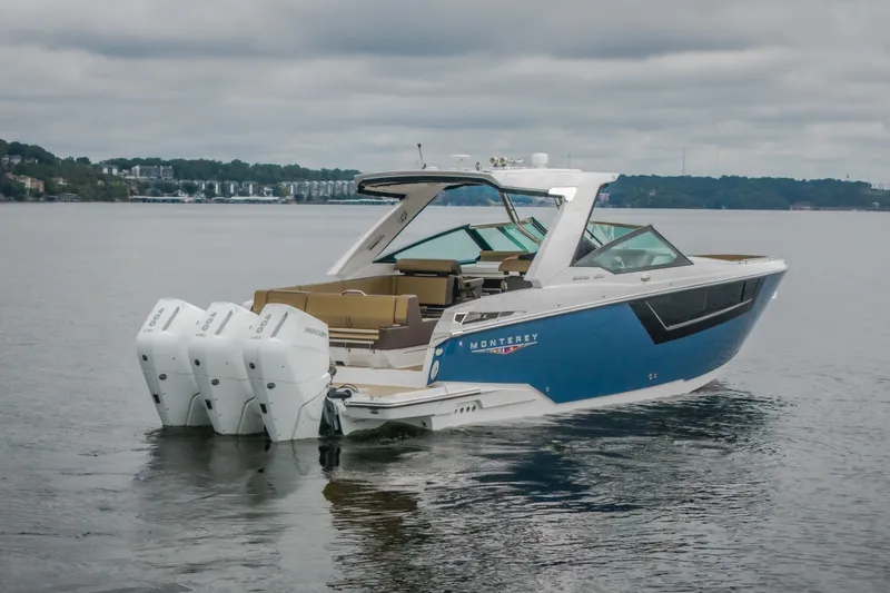 Slide: The Image of 2025 Monterey 385SS Super Sport boat on calm water, featuring triple outboard engines. - 66