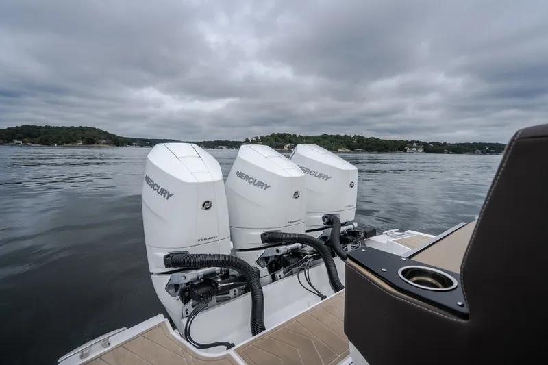 Slide: The Image of 2025 Monterey 385SS Super Sport boat with triple Mercury engines on a lake. - 63