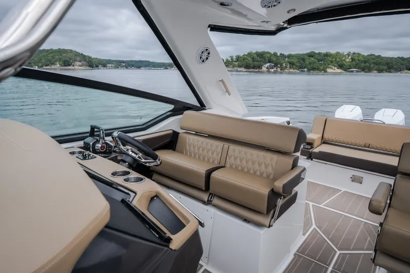 Slide: The Image of 2025 Monterey 385SS Super Sport boat interior with luxurious seating and modern dashboard. - 50