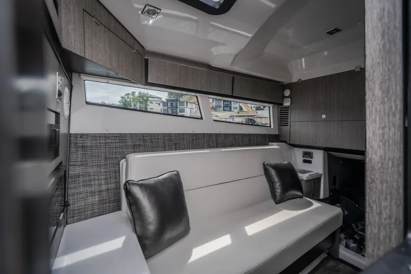 Slide: The Image of Luxurious interior of 2025 Monterey 385SS Super Sport boat with modern seating and cabinetry. - 26