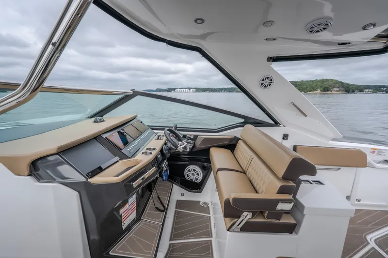 Slide: The Image of 2025 Monterey 385SS Super Sport boat interior with modern helm and luxurious seating. - 15
