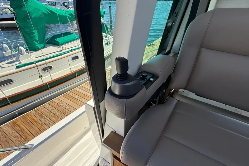 Slide: The Image of Interior view of 2026 Tiara Yachts EX 54, featuring helm controls and seating. - 15