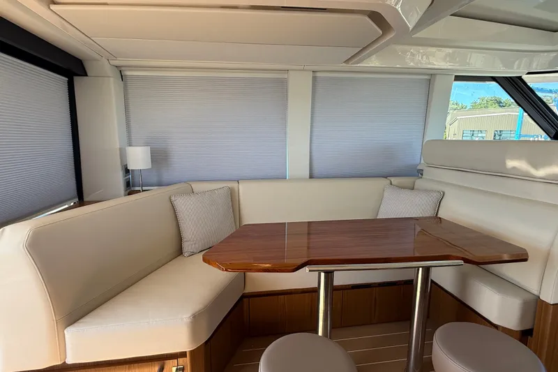 Slide: The Image of Luxurious interior of 2026 Tiara Yachts EX 54 with elegant seating and wooden table. - 9