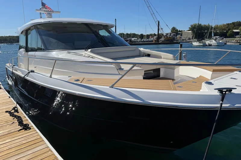 Slide: The Image of 2026 Tiara Yachts EX 54 docked, showcasing sleek design and luxurious deck features. - 2