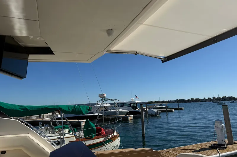 Slide: The Image of Luxury Tiara Yachts EX 54 docked, showcasing sleek design and waterfront view, 2026 model. - 35