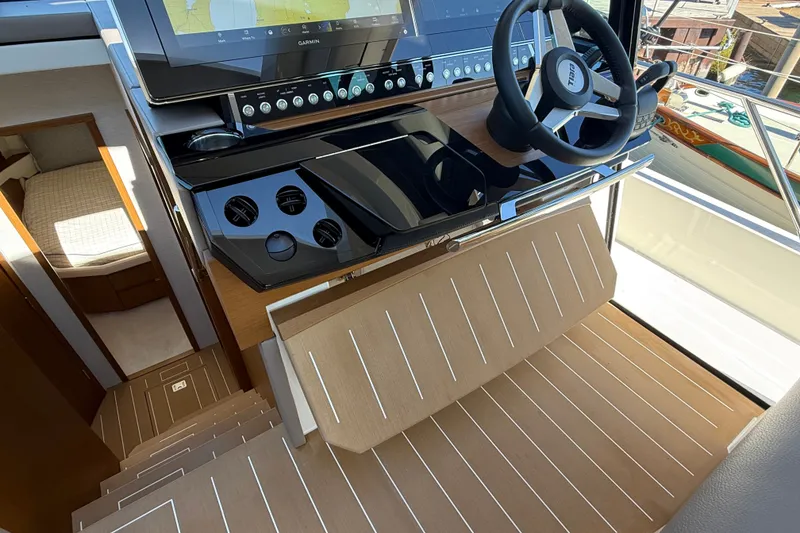 Slide: The Image of 2026 Tiara Yachts EX 54 helm with modern controls and sleek interior design. - 20