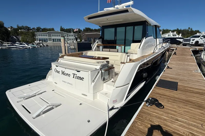 Slide: The Image of 2026 Tiara Yachts EX 54 docked, featuring spacious deck and modern design. - 3