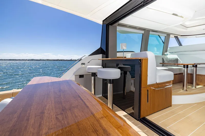 Slide: The Image of Manufacturer Provided Image: 2025 Tiara Yachts EX 54 interior with elegant seating and ocean view. - 46