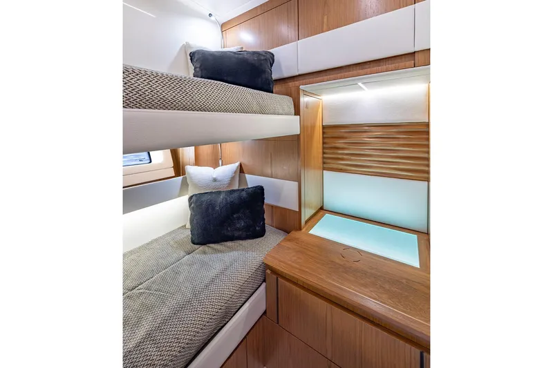 Slide: The Image of Manufacturer Provided Image: 2025 Tiara Yachts EX 54 interior with bunk beds and modern wood finish. - 54