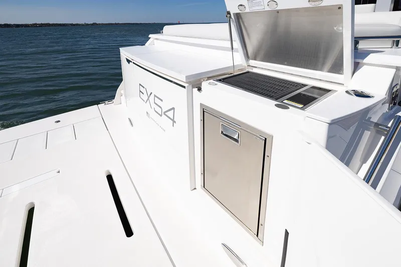 Slide: The Image of Manufacturer Provided Image: 2025 Tiara Yachts EX 54 deck with outdoor kitchen and storage, overlooking the water. - 42