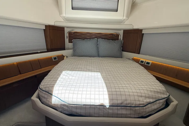 Slide: The Image of Luxurious bedroom interior of 2026 Tiara Yachts EX 54 with modern design and cozy bedding. - 24