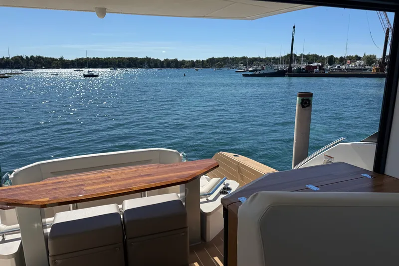 Slide: The Image of 2026 Tiara Yachts EX 54, rear deck view overlooking serene marina waters. - 36