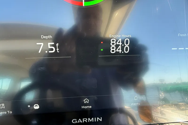 Slide: The Image of Garmin display on 2026 Tiara Yachts EX 54 showing depth and engine hours. - 17