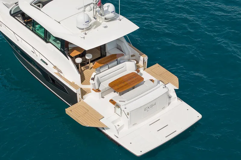 Slide: The Image of Manufacturer Provided Image: 2025 Tiara Yachts EX 54 luxury yacht with spacious deck and elegant seating on blue water. - 34