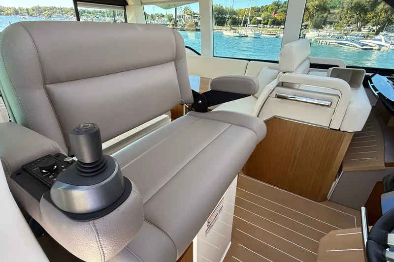 Slide: The Image of Interior of 2026 Tiara Yachts EX 54, featuring luxurious seating and modern controls. - 16