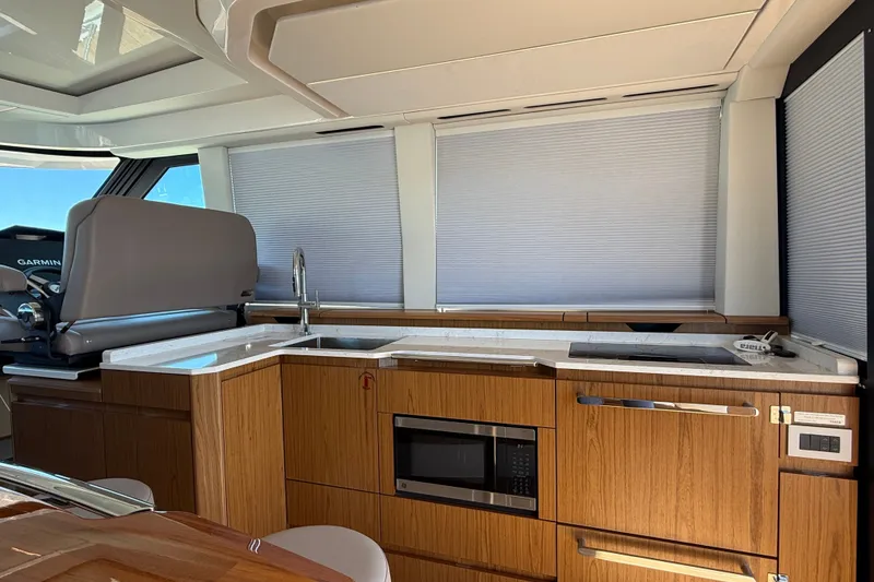 Slide: The Image of Luxurious interior of 2026 Tiara Yachts EX 54, featuring modern kitchen amenities. - 10
