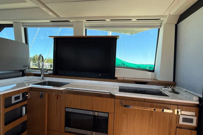 Slide: The Image of Luxurious interior of 2026 Tiara Yachts EX 54 with modern kitchen amenities. - 13