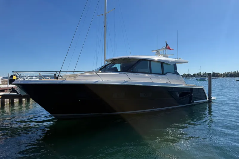 The Image of 2026 Tiara Yachts EX 54 luxury yacht docked in sunny marina. - 1