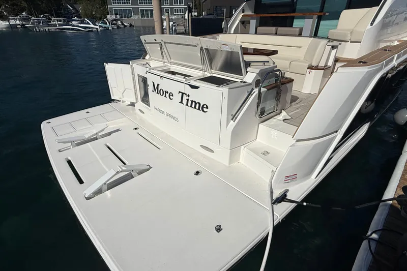 Slide: The Image of 2026 Tiara Yachts EX 54, rear view with swim platform and seating area. - 4