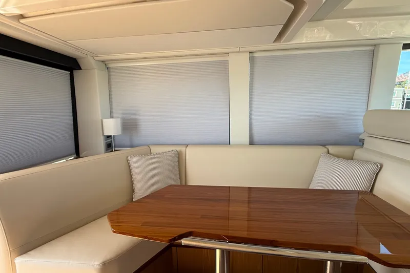 Slide: The Image of Luxurious interior of 2026 Tiara Yachts EX 54 with elegant seating and wooden table. - 8