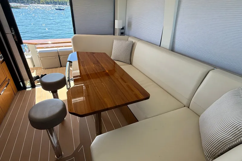 Slide: The Image of Luxurious interior of 2026 Tiara Yachts EX 54 with elegant seating and wooden table. - 11