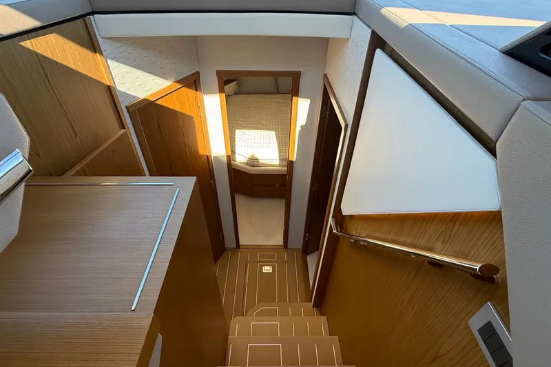 Slide: The Image of Interior view of 2026 Tiara Yachts EX 54, featuring elegant wood finishes and modern design. - 21