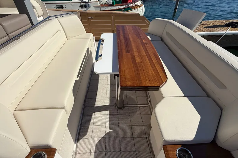Slide: The Image of Luxurious seating area on 2026 Tiara Yachts EX 54 with elegant wooden table. - 5