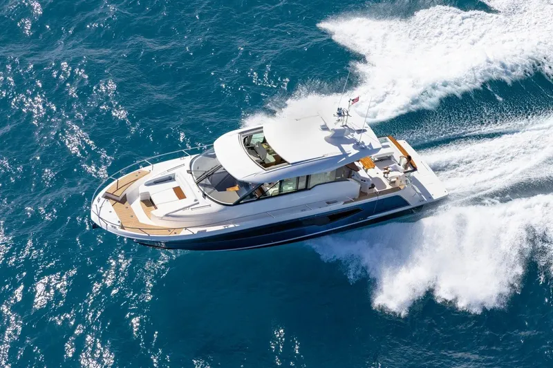 Slide: The Image of 2026 Tiara Yachts EX 54 cruising on open blue waters, aerial view. - 23