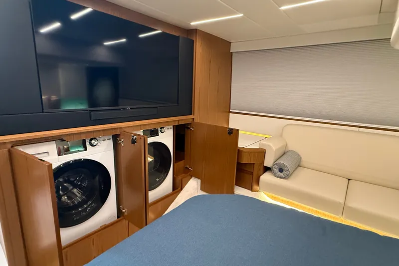 Slide: The Image of Luxurious interior of 2026 Tiara Yachts EX 54 with TV, washer, and cozy seating. - 30