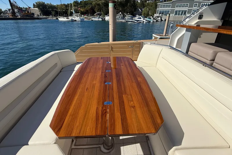 Slide: The Image of Luxurious seating area on 2026 Tiara Yachts EX 54, featuring elegant wooden table. - 6