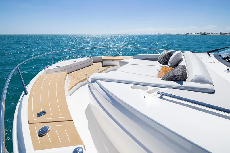 Slide: The Image of Manufacturer Provided Image: 2025 Tiara Yachts EX 54 luxury yacht deck with cushions, overlooking serene ocean waters. - 32