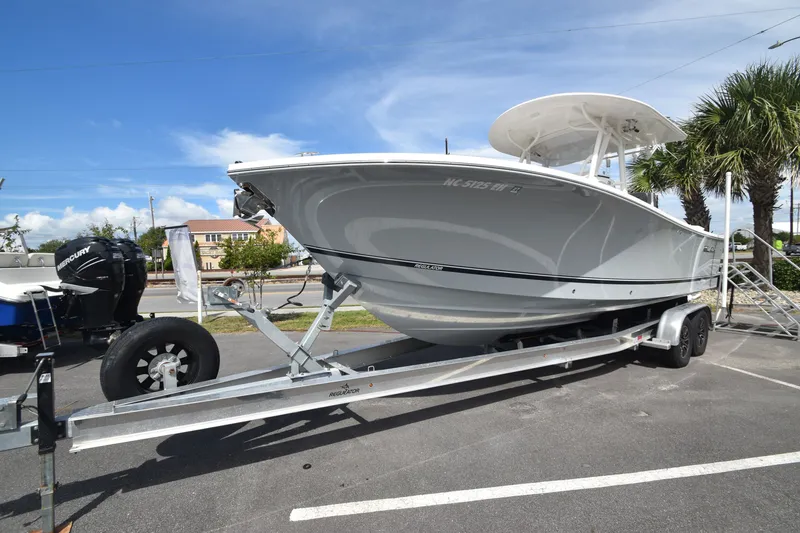 The Image of A 2018 Regulator 28 Forward Seating boat on a trailer, parked in a lot. - 0
