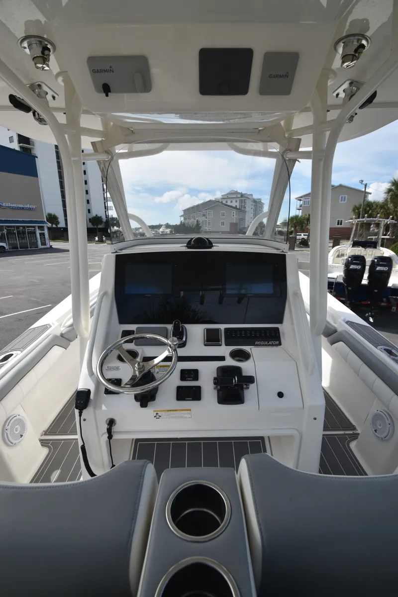 Slide: The Image of The image shows the cockpit of a 2018 Regulator 28 Forward Seating boat with modern electronics. - 4