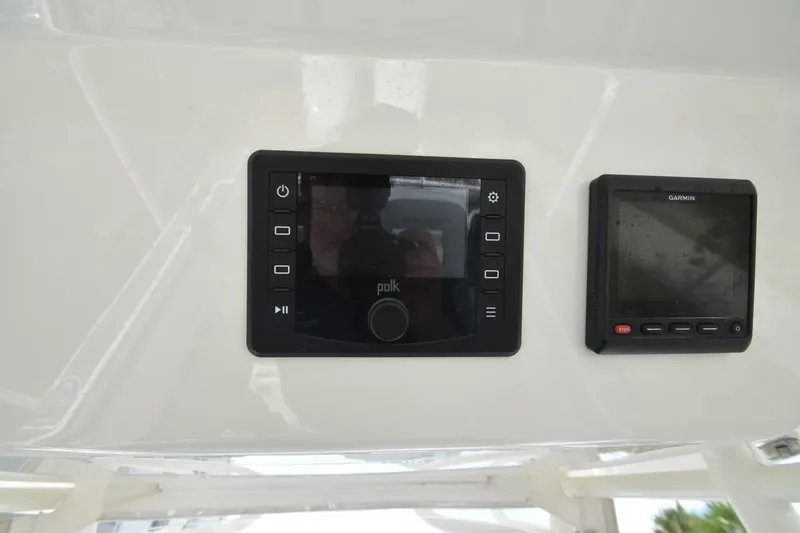 Slide: The Image of A helm station featuring a Polk audio system and a Garmin device, mounted on a white surface. - 12