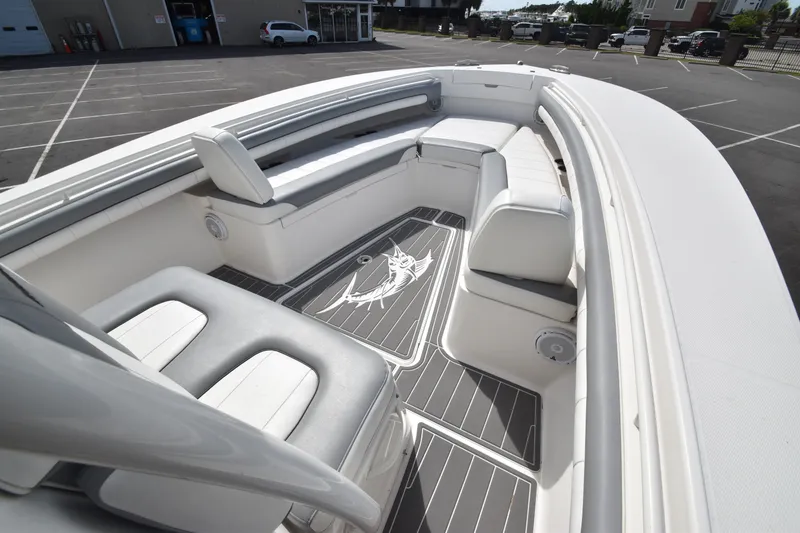 Slide: The Image of The image shows the bow of a 2018 Regulator 28 Forward Seating boat with white upholstery. - 6